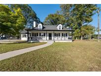 Charming one-story home with white exterior and black accents at 1368 New Hope Rd, Lawrenceville, GA 30045