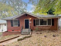 Charming brick home with black shutters and landscaping at 2986 Harlan Dr, Atlanta, GA 30344