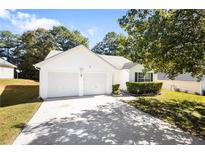 Two-car garage and well-maintained front lawn at 10654 Village Lndg, Jonesboro, GA 30238