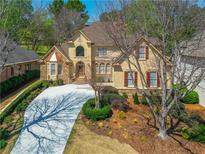 An elegant two-story house with a large driveway and landscaping at 8120 Turnberry Way, Duluth, GA 30097