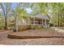 Ranch style home with stone accents and a covered porch at 175 Carriage Gate Dr, Sharpsburg, GA 30277