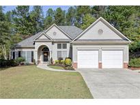 Two-story house with two-car garage and manicured lawn at 131 Paddington Pl, Acworth, GA 30101