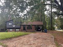 Brick ranch house with a carport and mature trees at 3230 Vanderbilt Nw Ln, Atlanta, GA 30318