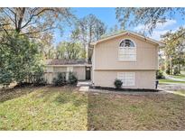 Beige two-story house with a landscaped yard at 3276 Marlanta Dr, Marietta, GA 30062