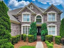 Brick two-story house with manicured lawn and landscaping at 225 Asante Dr, Ellenwood, GA 30294