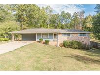 Ranch style home with brick and light blue accents, situated on a grassy lot at 6275 S Skyline Dr, Douglasville, GA 30135