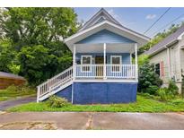 Charming blue bungalow with a front porch and well-maintained landscaping at 1048 Garibaldi Sw St, Atlanta, GA 30310