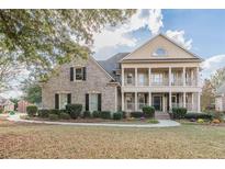Two-story brick home with a front porch and landscaped yard at 4348 Meadow Vista Dr, Stonecrest, GA 30038