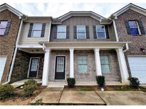 Two-story townhome with brick and siding at 1535 Iris Walk, Jonesboro, GA 30238