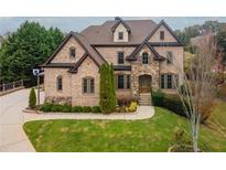 Brick front exterior of a luxurious two-story home with landscaping at 3960 Carissa Trce, Cumming, GA 30040