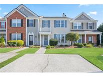 Two-story townhome with brick and siding, landscaping, and driveway at 1730 Stanwood Nw Dr, Kennesaw, GA 30152