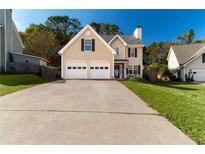 Two-story house with a two-car garage and well-manicured lawn at 215 Mackenzie Ct, Canton, GA 30115