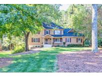 Two-story house with a wraparound porch, situated on a grassy lot at 5892 Smoke Rise Ct, Stone Mountain, GA 30087