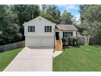 Two-car garage and a well-maintained lawn at 389 Rustin Dr, Dallas, GA 30157
