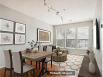 Virtually staged living room with hardwood floors and large windows at 821 Ralph Mcgill Ne Blvd # 3404, Atlanta, GA 30306