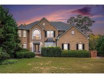 Two story brick home with landscaped yard at 9140 N Links Dr, Covington, GA 30014