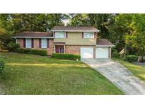 Brick house with two car garage and manicured lawn at 5135 Erin Sw Rd, Atlanta, GA 30331