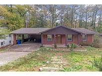 Brick ranch house with carport and landscaping at 2314 Omaha Sw Rd, Atlanta, GA 30331