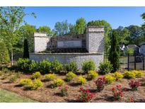 Community entrance with landscaping and signage at 155 Wards Crossing Way # 118, Johns Creek, GA 30022