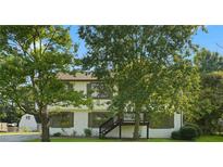 Two-story house exterior with mature trees and a deck at 3430 Brushy Fork Rd, Loganville, GA 30052