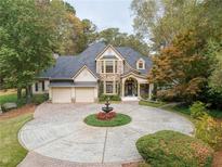 Elegant two-story home with circular driveway and fountain at 125 Claridge Dr, Atlanta, GA 30342