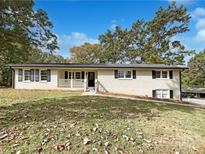 Charming ranch home with brick exterior and landscaped yard at 3811 Reynolds Rd, Douglasville, GA 30135
