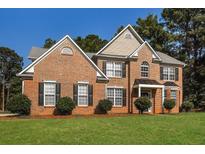 Brick two-story house with a nicely landscaped lawn at 105 Argonne Dr, Fayetteville, GA 30214