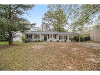 Ranch style home with carport and mature trees at 6940 Kimberly Mill Rd, Atlanta, GA 30349