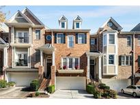 Brick townhouses with attached garages and manicured landscaping at 226 Mclaren Gates Dr, Marietta, GA 30060