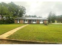 Ranch style brick home with a well-maintained lawn at 3759 Stanford Cir, Decatur, GA 30034
