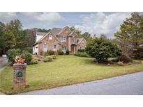 Brick two-story house with landscaped yard at 2194 Ne Indian Shoals Dr, Loganville, GA 30052