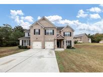 Two-story brick house with three-car garage at 6788 Oconee Pl, Fairburn, GA 30213