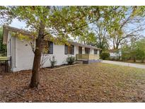 Charming ranch home with updated front porch and landscaping at 200 Sunrise Cir, Riverdale, GA 30274