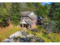 Brick house with large yard, driveway, and surrounding trees at 250 Big Oak Rd, Whitesburg, GA 30185