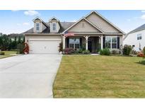 House exterior featuring a two-car garage and well-manicured lawn at 90 Hickory Pointe Dr, Acworth, GA 30101