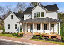 Charming two-story farmhouse with front porch at 64 Maple St, Roswell, GA 30075