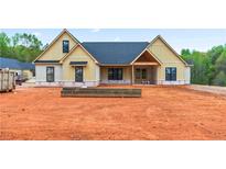 New construction home exterior, featuring a light yellow facade and a dark gray roof at 3337 Horsley Mill Rd, Carrollton, GA 30116