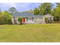 Charming ranch home with red door and stone accents at 3575 Bright Star Rd, Douglasville, GA 30135