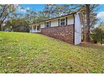 Ranch home with brick facade and a spacious yard at 117 Neal Ave, Stockbridge, GA 30281
