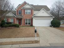 Brick two-story house with a large driveway and landscaped lawn at 102 Ozark Trl, Canton, GA 30114