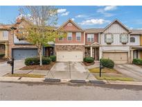 Row of townhouses showcasing variety of exterior finishes at 3333 Castleberry Village Cir, Cumming, GA 30040