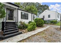 Charming white house with black accents and a well-maintained yard at 4118 Clairmont Rd, Chamblee, GA 30341