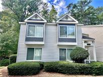 Charming two-story townhome with gray siding and landscaping at 12 Rumson Ct, Smyrna, GA 30080