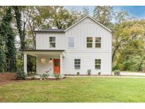 Charming two-story farmhouse with a bright orange door at 844 Ridge Nw Ave, Atlanta, GA 30318