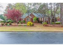 Brick home with landscaped yard and mature trees at 1510 Natchez Way, Grayson, GA 30017