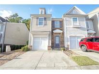Two-story townhome with attached garage and landscaping at 2158 Executive Dr, Duluth, GA 30096
