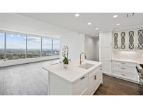 Modern white kitchen with marble island and city views at 3630 Peachtree Ne Rd # 3106, Atlanta, GA 30326
