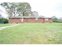 Brick ranch house with a spacious lawn at 680 Sherwood Dr, Jonesboro, GA 30236