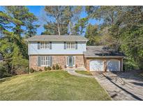 Brick and light blue sided two-story house with a two-car garage and manicured lawn at 2958 Applewood Ne Ct, Atlanta, GA 30345