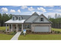 Gray two-story house with a metal roof, brick facade, and a two-car garage at 3759 Tielman St, Snellville, GA 30078